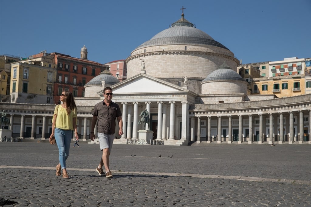 Couple exploring Piazza del Plebiscito, Naples