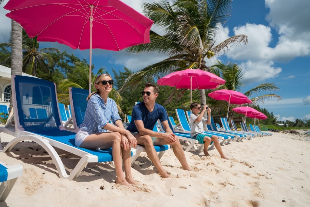 Family lounging on Seven Mile Beach, Grand Cayman