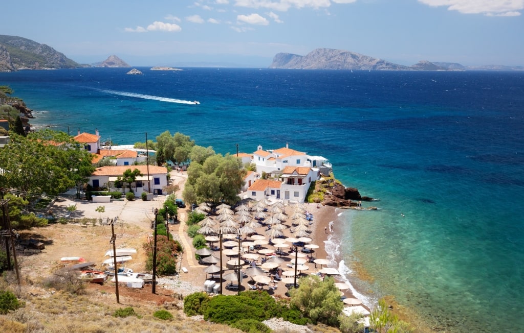 Umbrellas lined up on a beach in Hydra