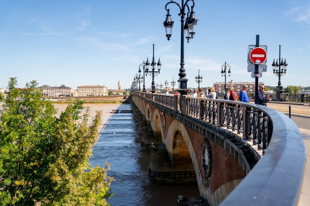 People passing by Pont de Pierre, Old Bordeaux