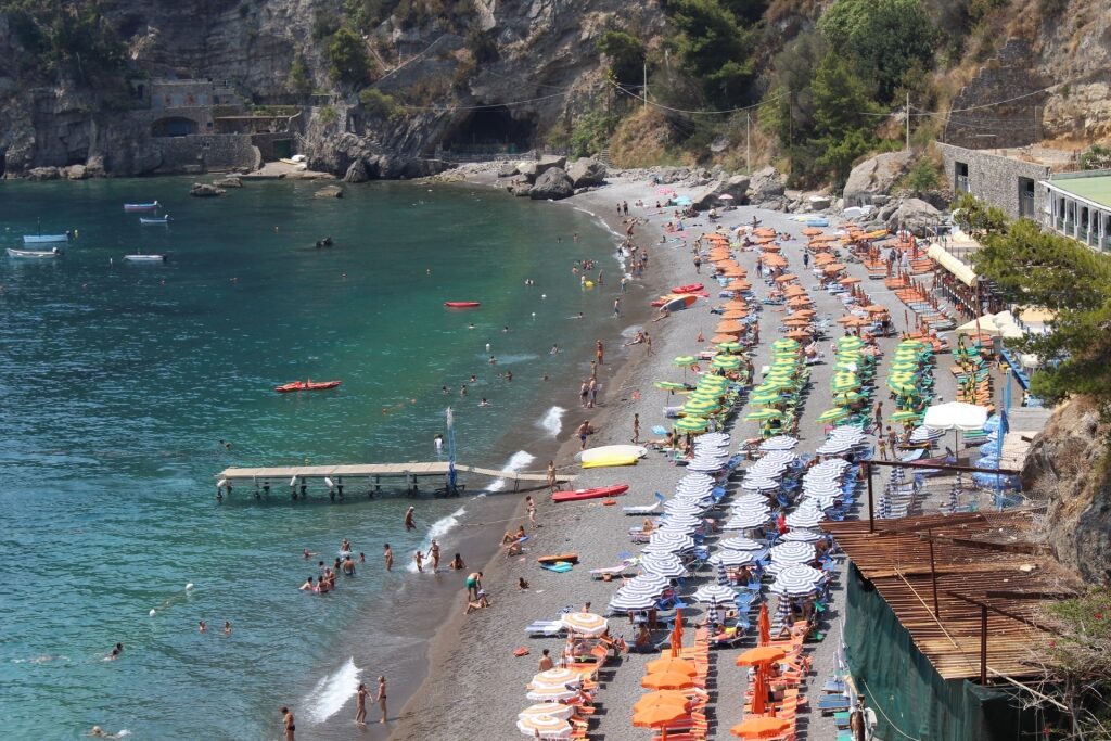 People lounging on Fornillo Beach, Positano