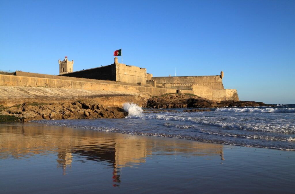 Historic São Julião da Barra Fort towering over the beach