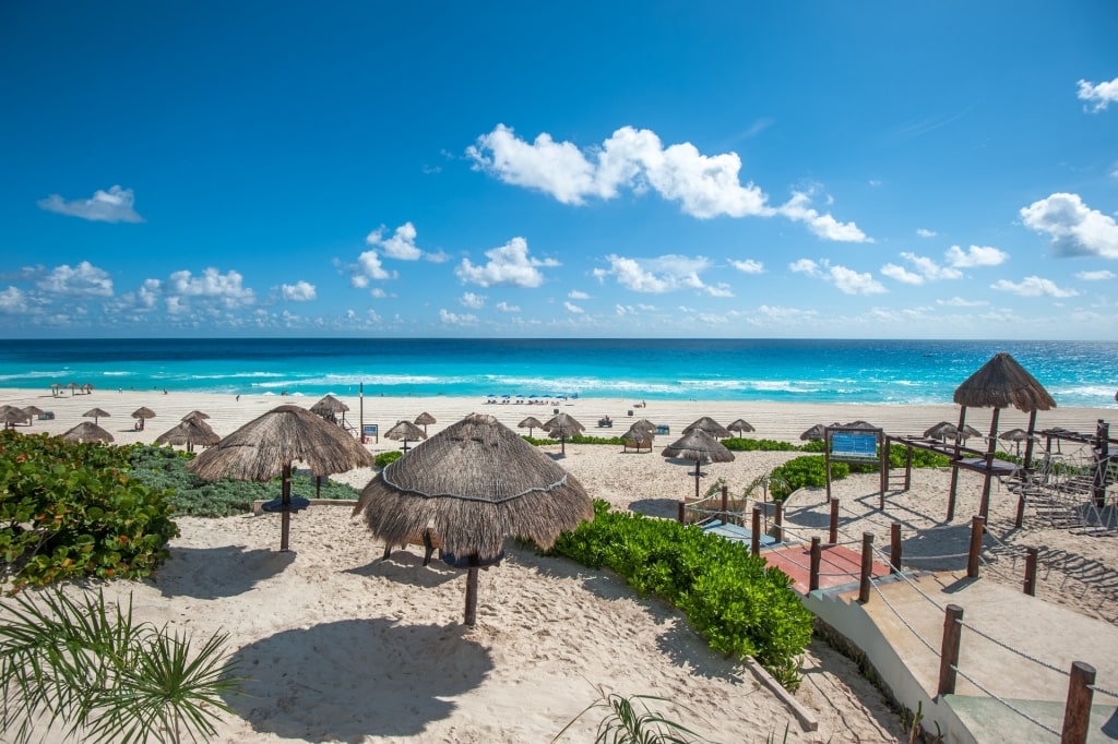 Beach umbrellas lined up on Dolphin Beach, Cancun