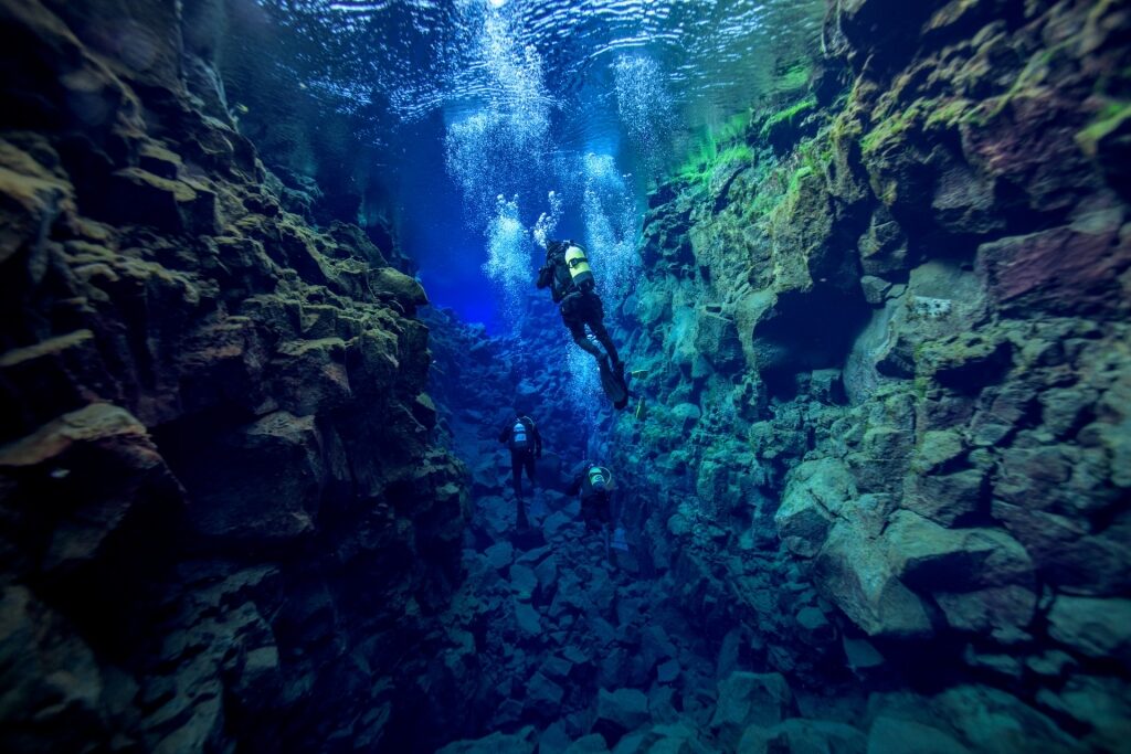 People scuba diving in Silfra Fissure, Iceland