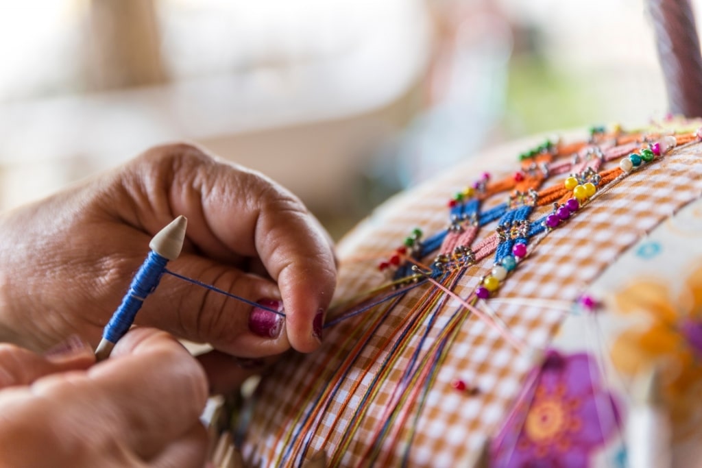 Person weaving using mundillo