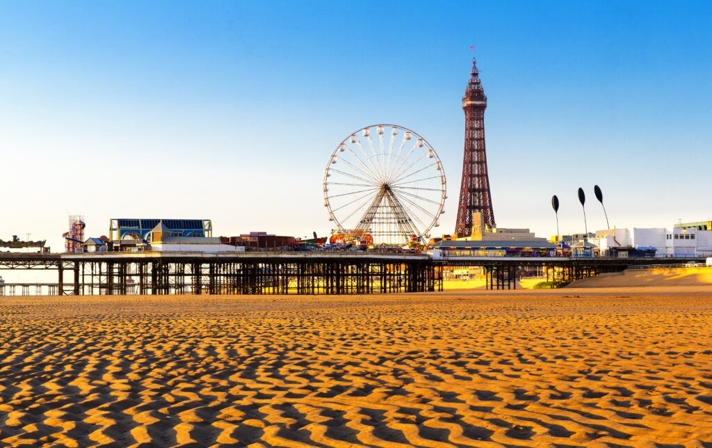 Ferris wheel and tower seen from Blackpool Beach in Blackpool, England