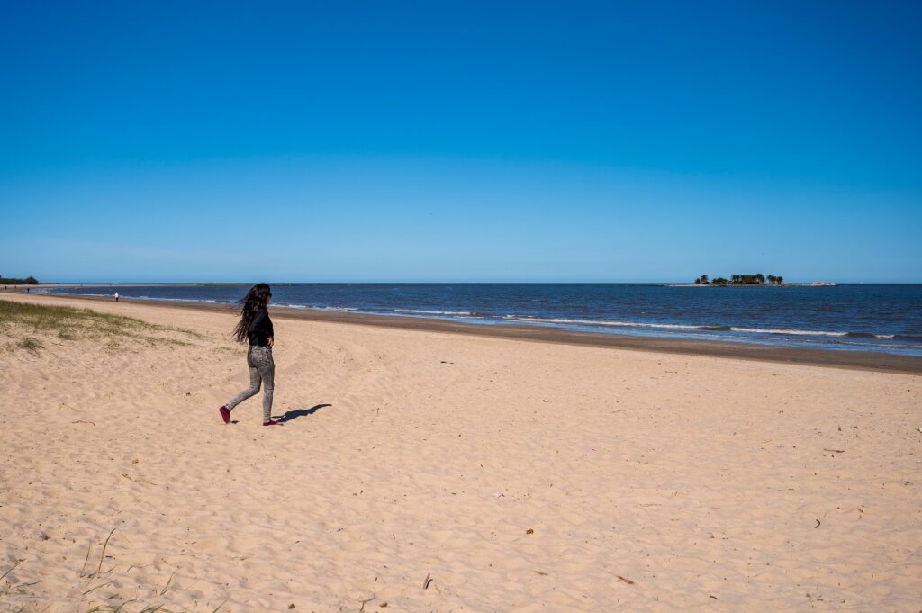 Woman strolling Playa Malvin, Montevideo