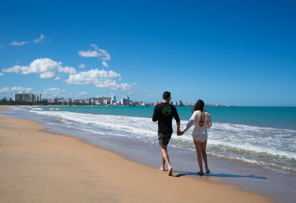 Couple strolling Isla Verde Beach