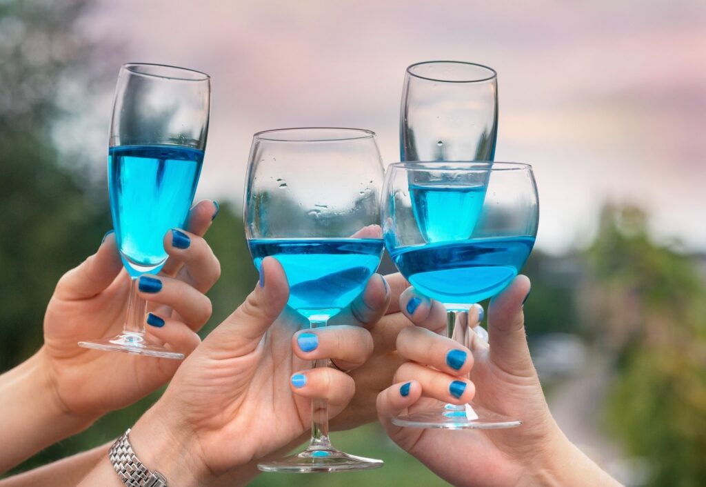 People drinking blue wine