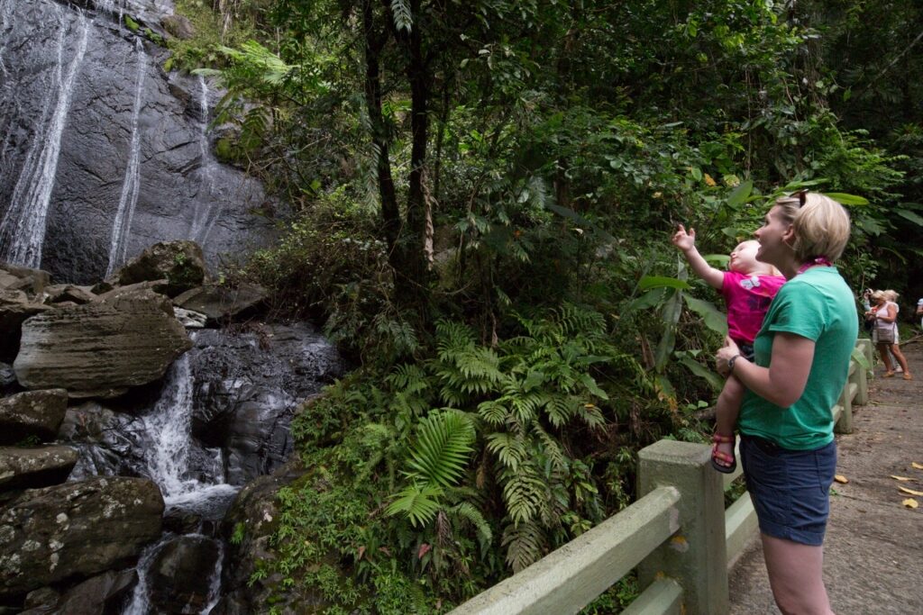 People sighseeing in La Coca Waterfall, El Yunque Rainforest