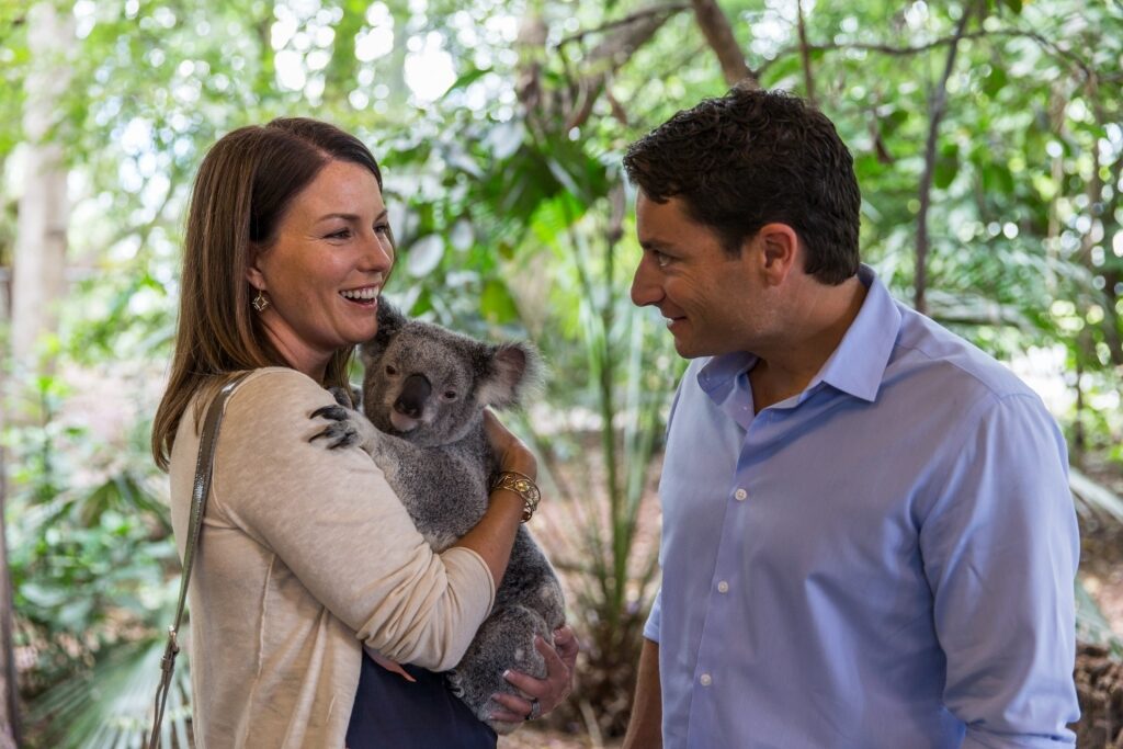Couple cuddling with a koala at the Lone Pine Koala Sanctuary