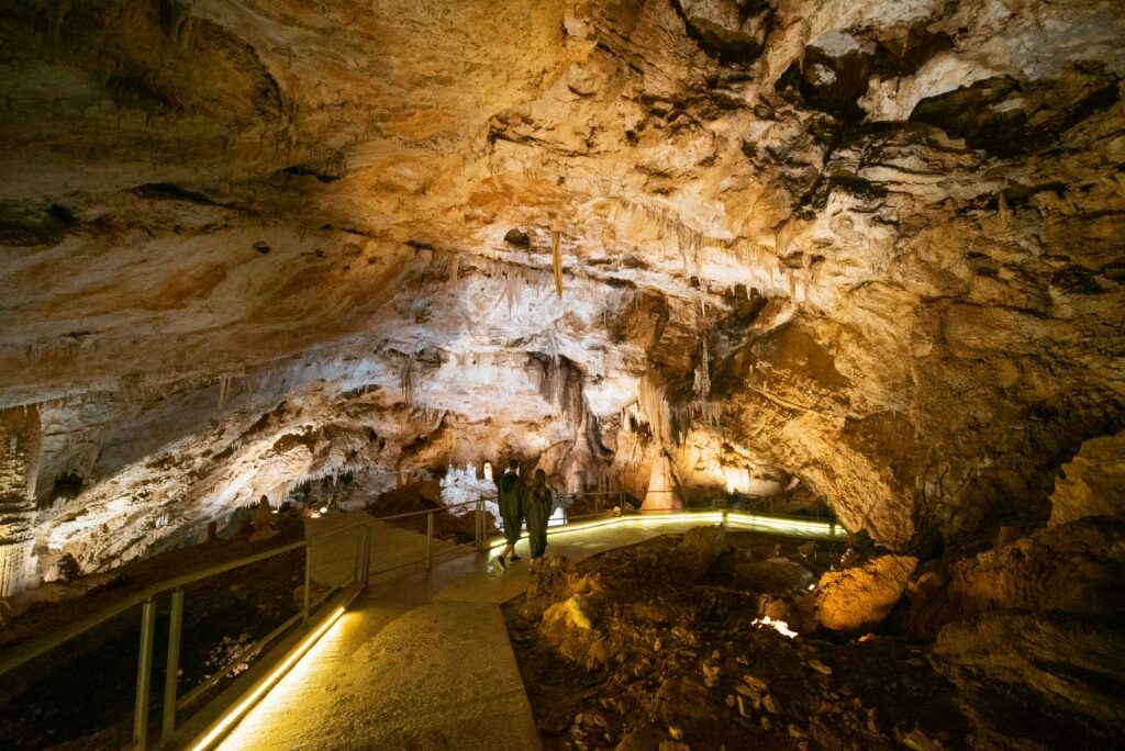 Couple exploring Lipa Cave, near Kotor, Montenegro