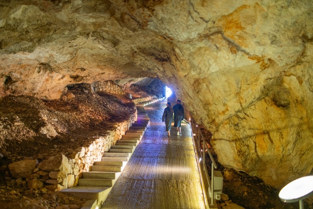 Couple exploring Lipa Cave, near Kotor, Montenegro