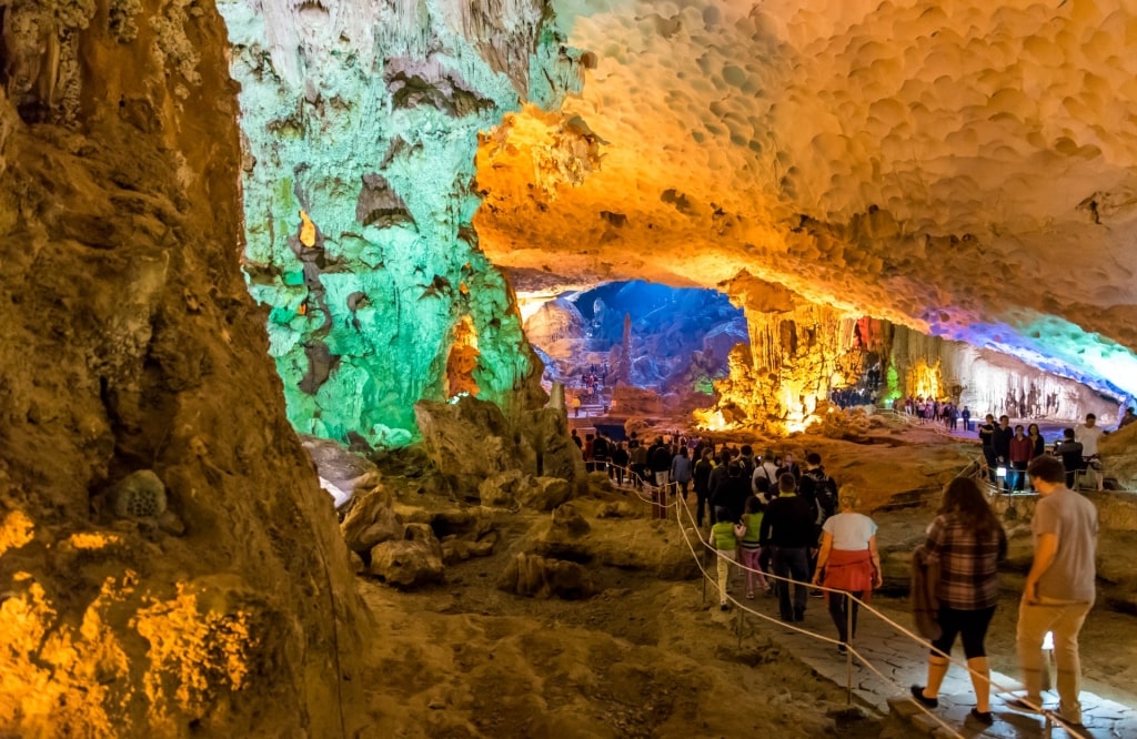 People exploring Sung Sot Cave in Halong Bay, Vietnam