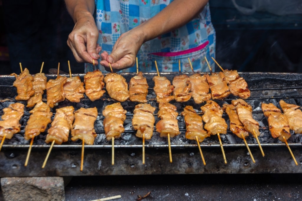 Woman grilling Moo ping