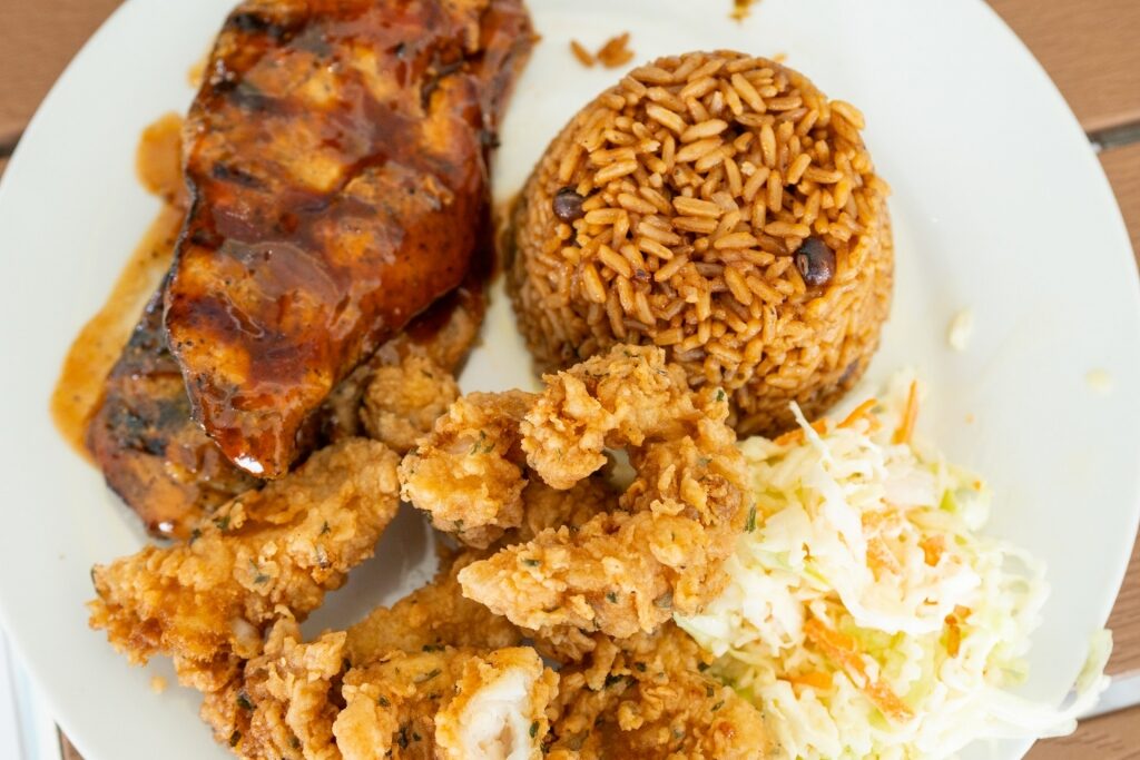 Caribbean food with conch fritters and jerked meat