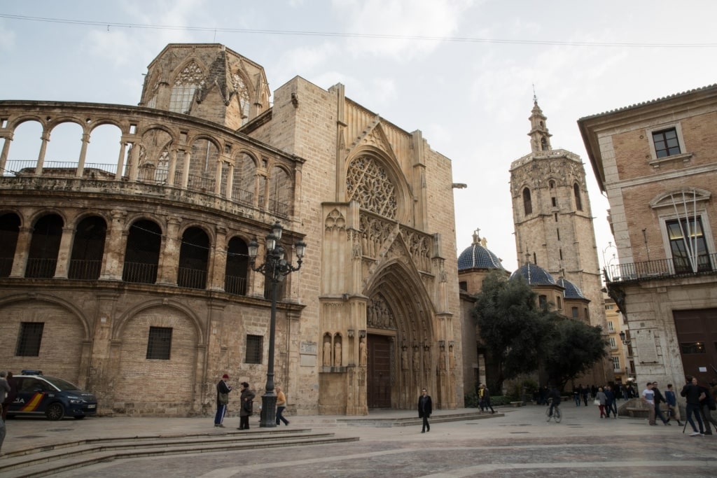 People walking along Valencia Cathedral, Spain