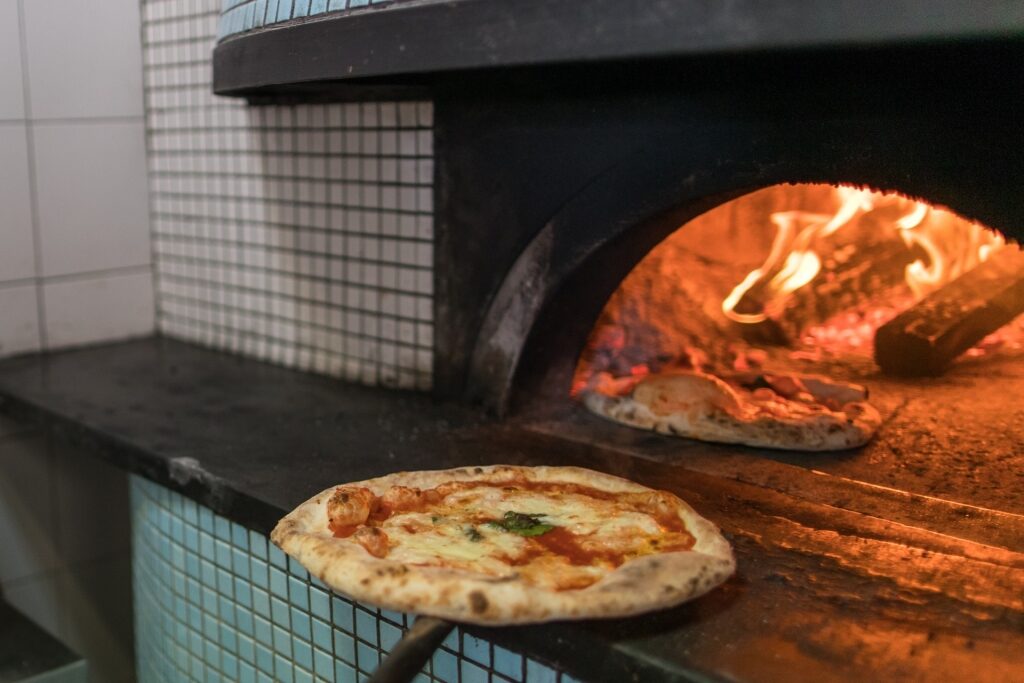 Cooking pizza in a wood-fired oven