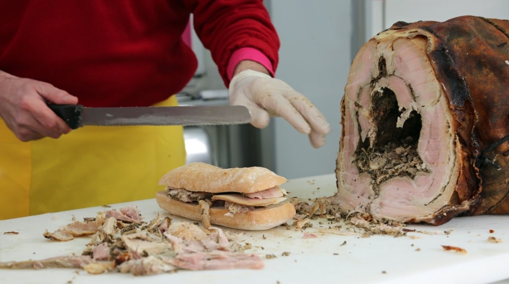 Man preparing porchetta panini