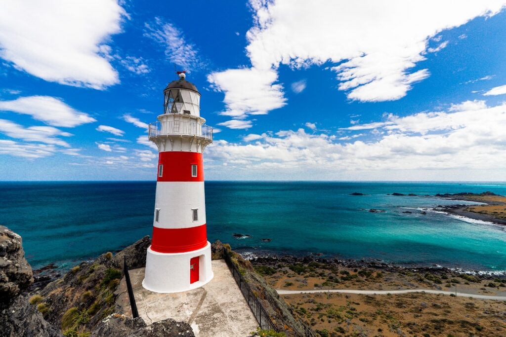 Red and white exterior of Cape Palliser Lighthouse, near Wellington, New Zealand