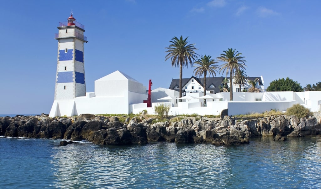 Blue and white facade of Santa Marta Lighthouse, near Lisbon, Portugal