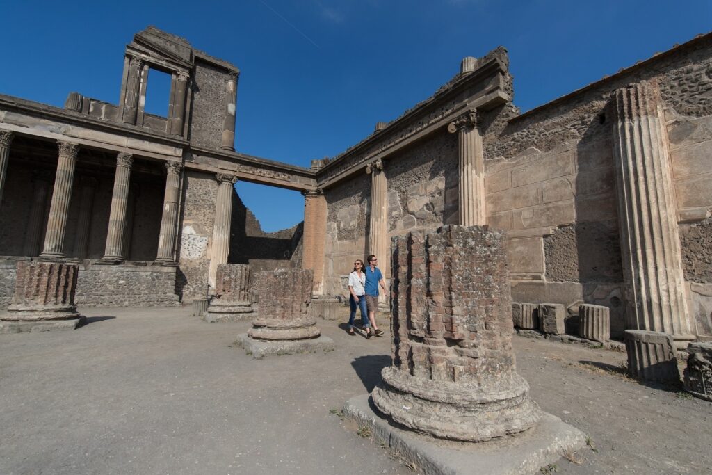 Couple strolling Pompeii Archaeological Park, Naples