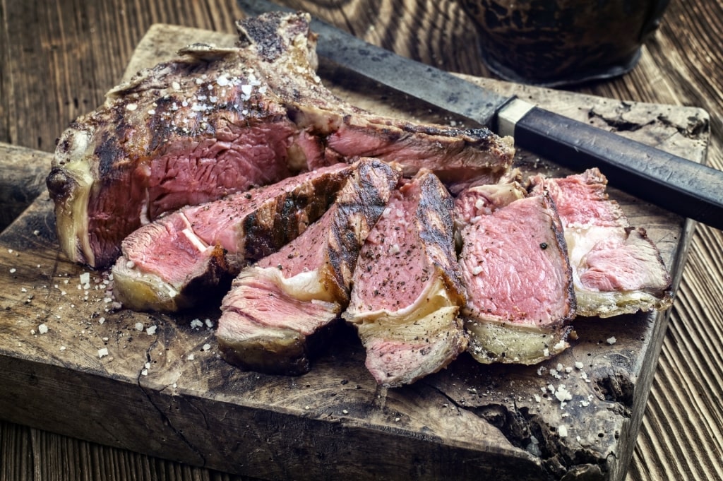 Bistecca alla Fiorentina on a wooden plate