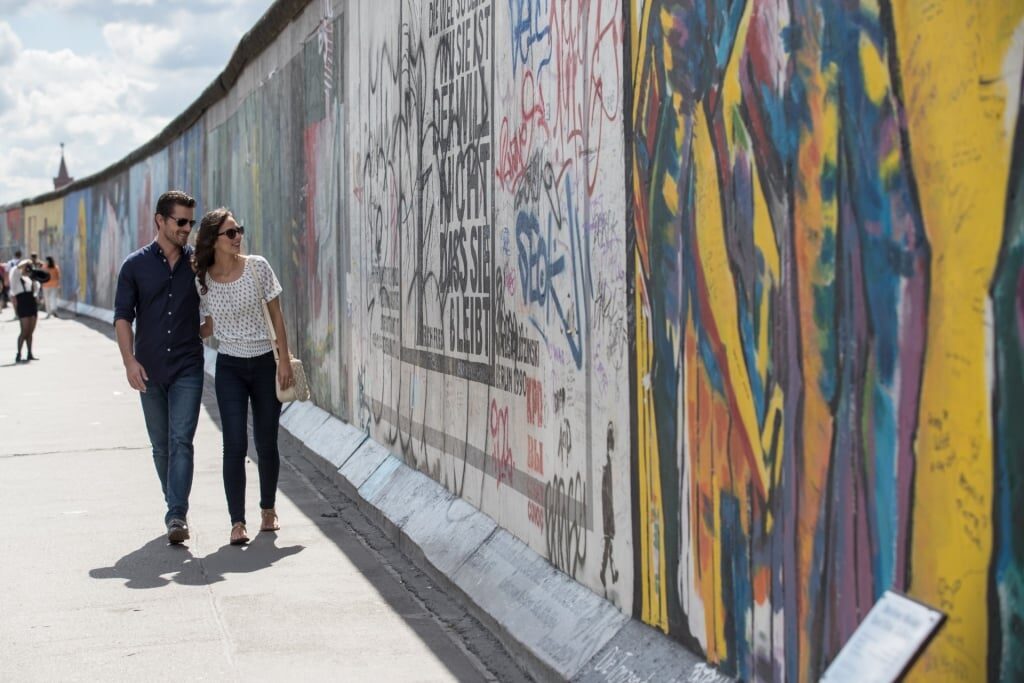 Couple walking along the Berlin Wall in Berlin, Germany