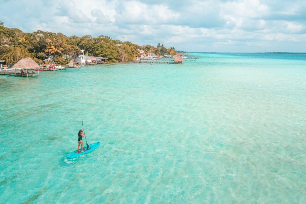 Woman paddling in Laguna Bacalar, near Costa Maya