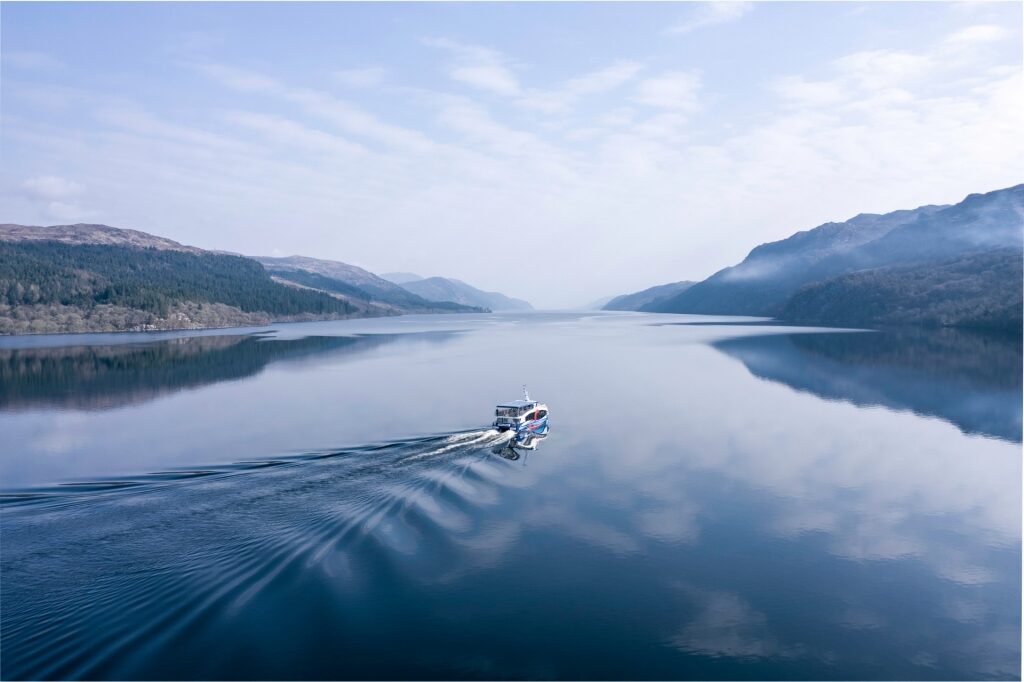 Boat cruising through Loch Ness, Scotland