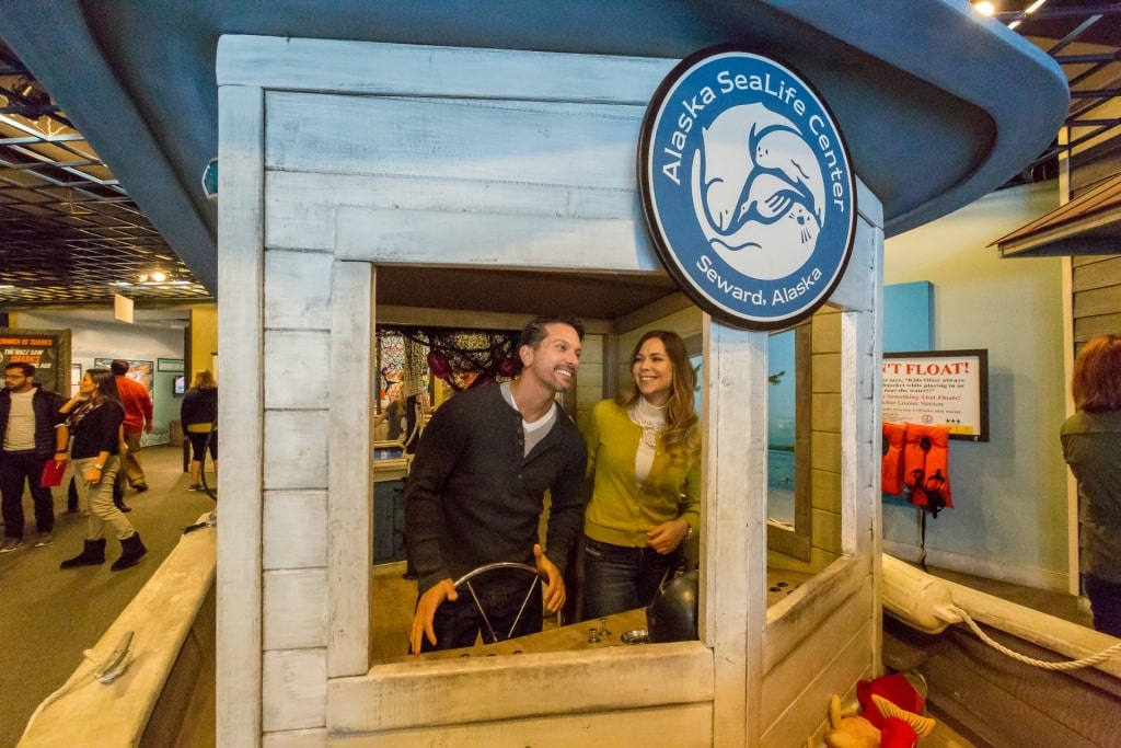 Couple having fun inside the Alaska SeaLife Center, Seward