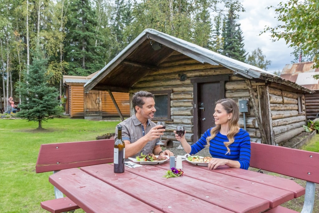 Couple eating salmon in Alaska Salmon Bake, Fairbanks