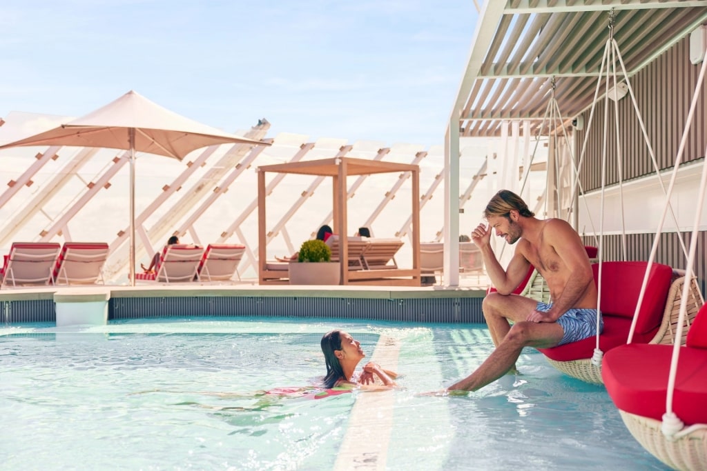 Couple relaxing on the Retreat Sundeck aboard Celebrity Cruises