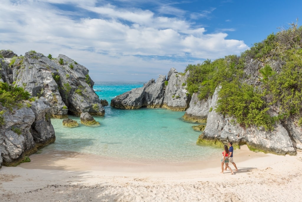 Couple walking along Jobson’s Cove, Bermuda