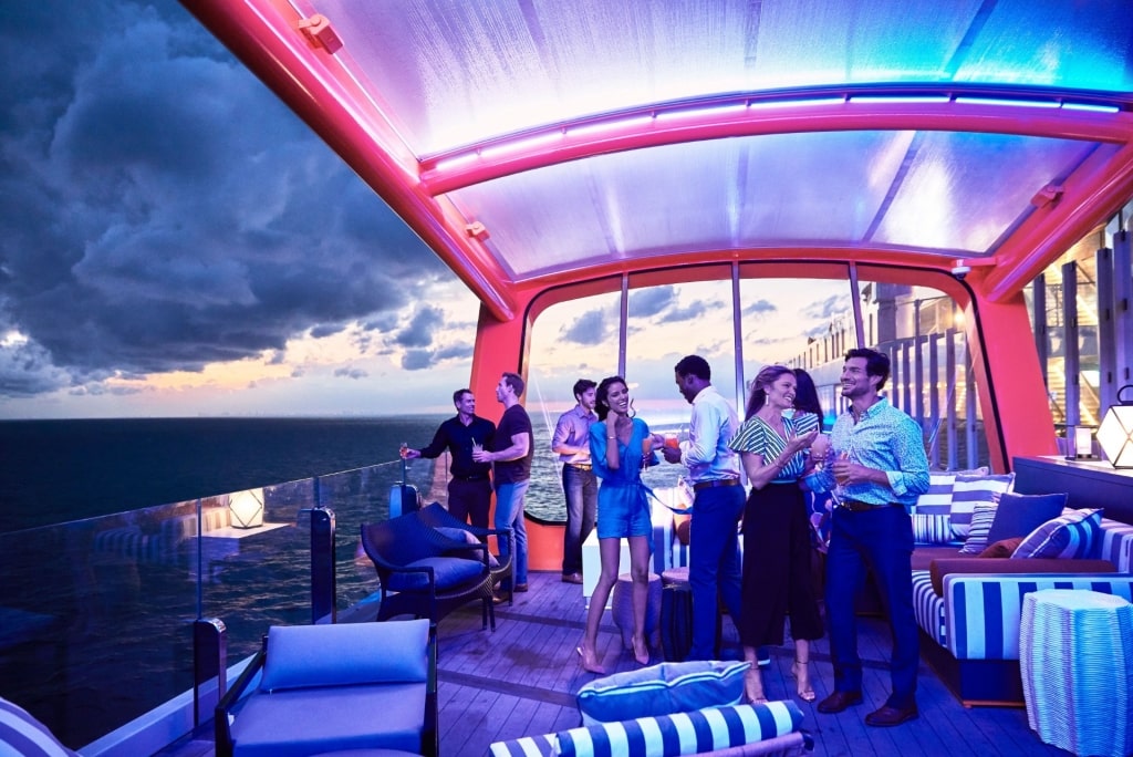 People enjoying drinks aboard Celebrity Cruises' Magic Carpet