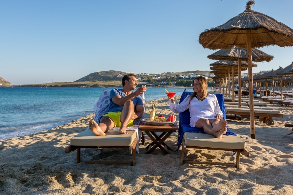 Couple relaxing on Kalafatis Beach, Mykonos