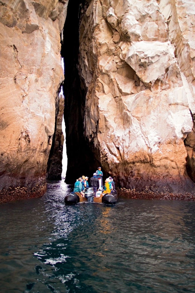 People on a boat tour through Kicker Rock