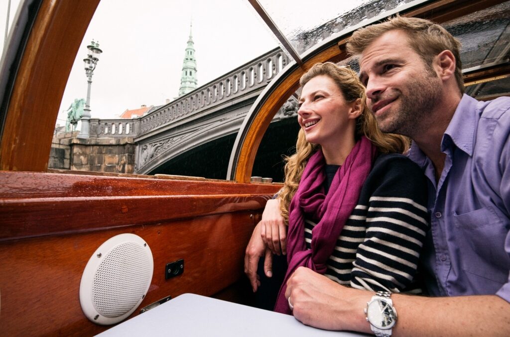 Couple on a canal cruise in Copenhagen, Denmark