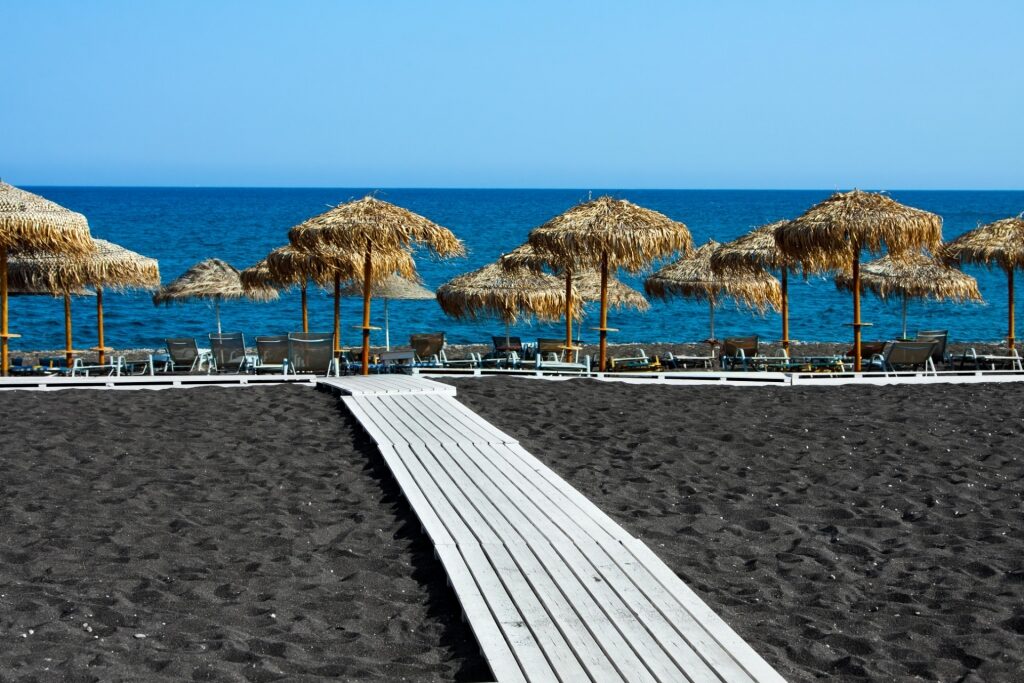 Black sands of Perivolos Beach in Santorini, Greece