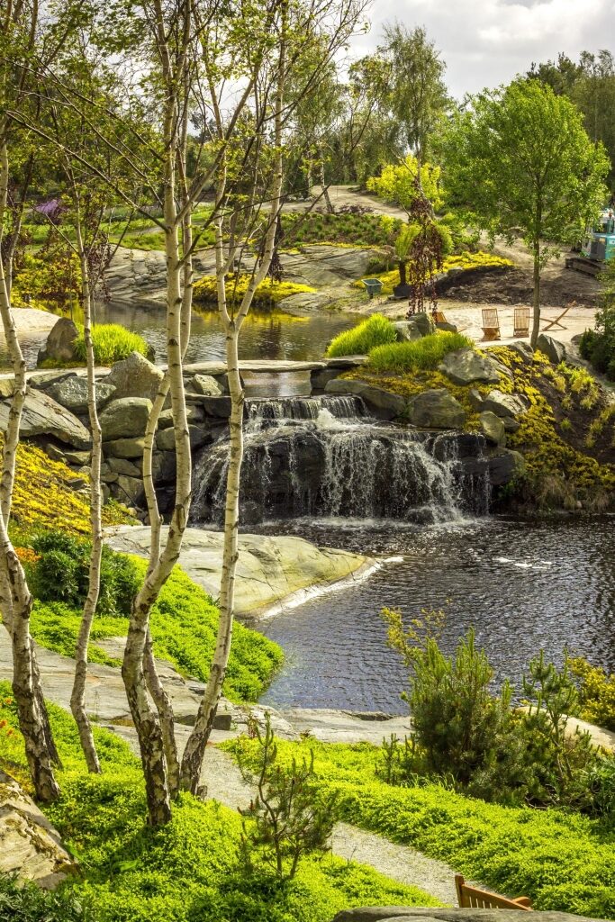 Lush landscape of Flor and Fjære Garden with waterfalls