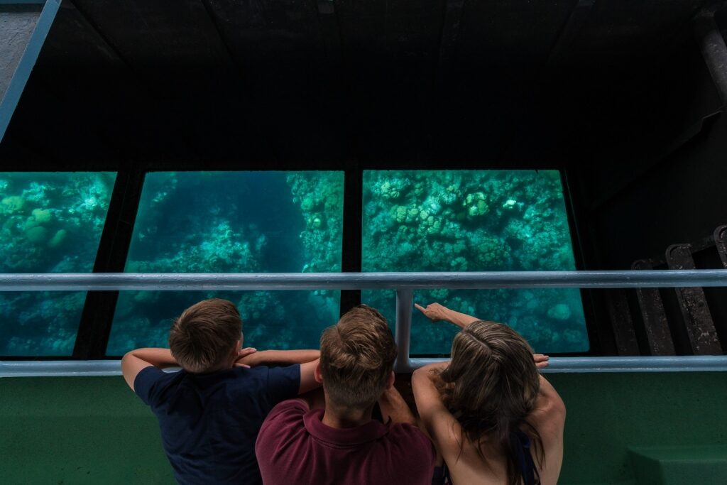 People on a glass-bottom boat tour in Grand Cayman