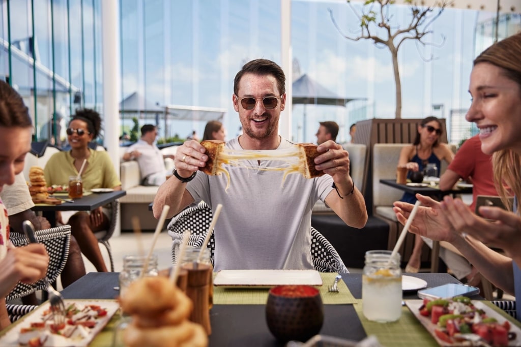 People enjoying food from the Rooftop Garden, Celebrity Ascent