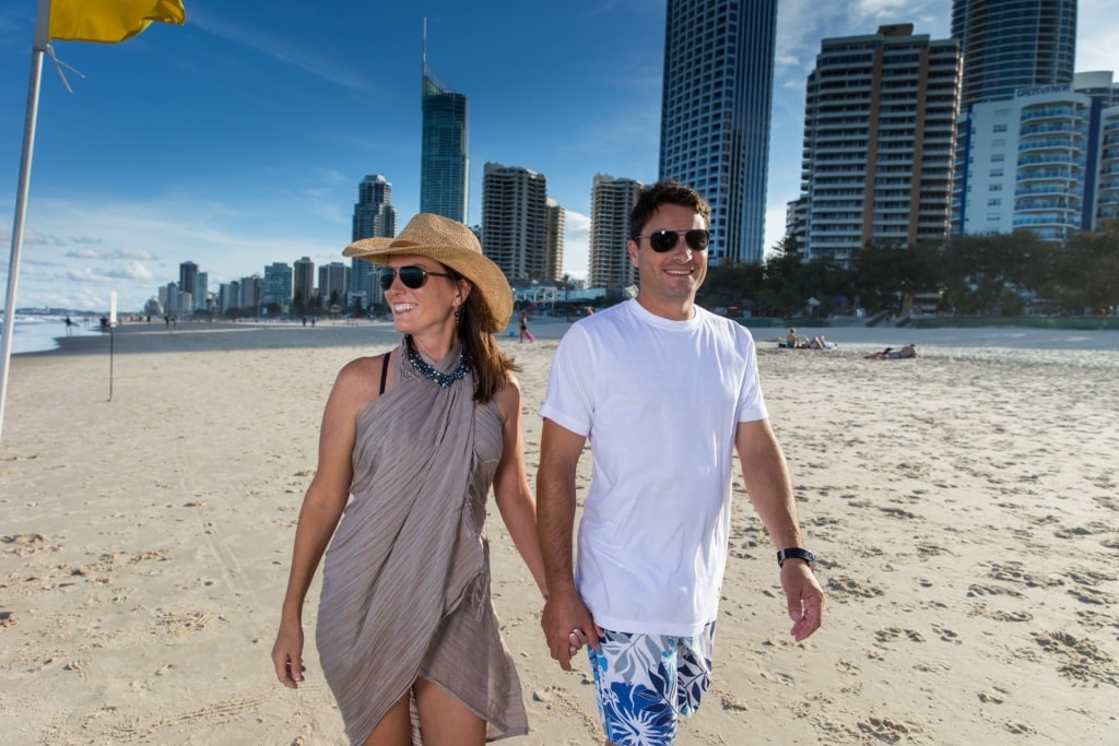 Couple exploring the sandy beach of Gold Coast, Australia