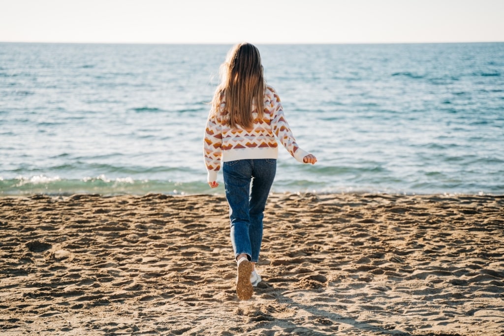 Woman wearing sweater at the beach