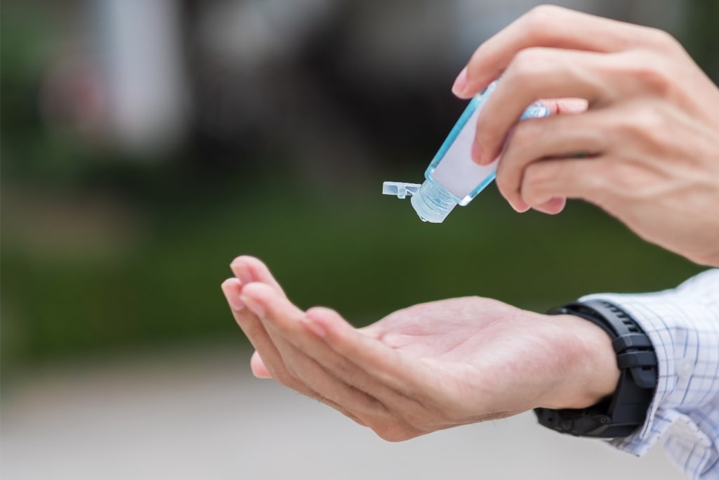 Man applying hand sanitizer