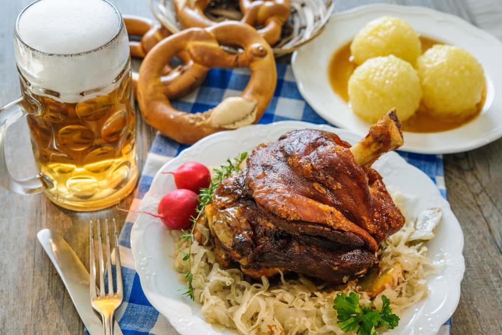 Plate of schweinshaxe on a table with beer