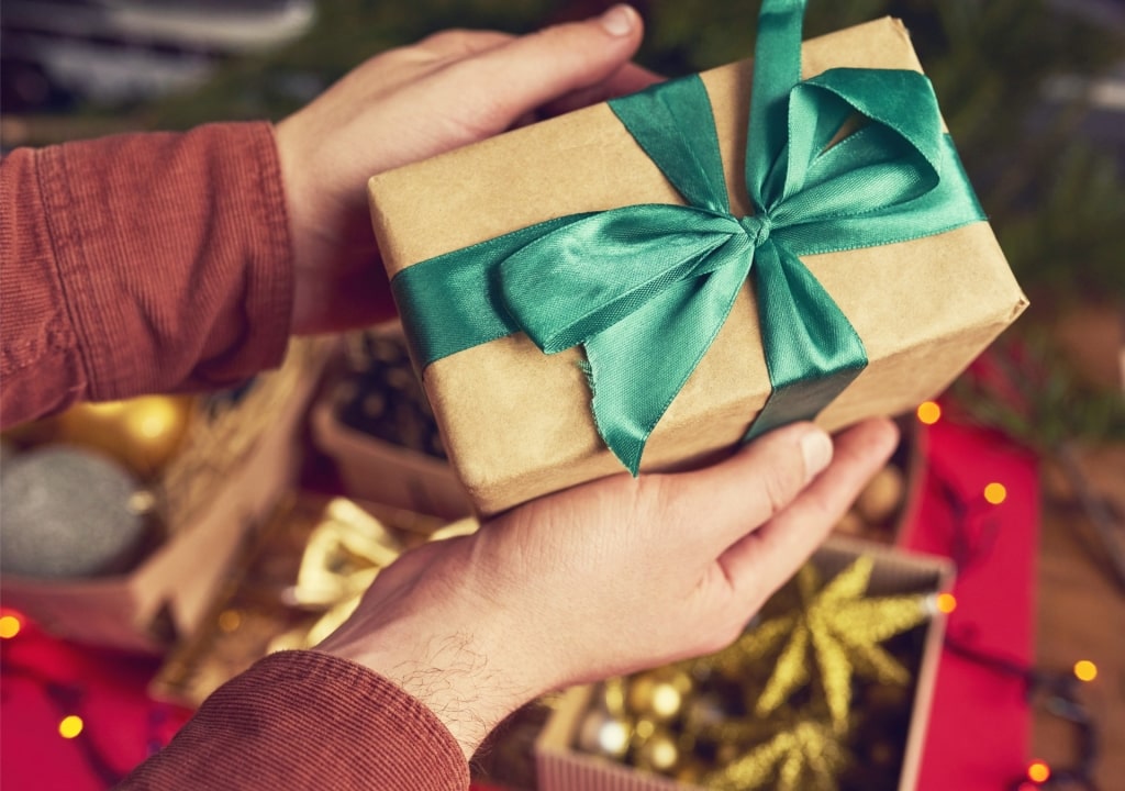 Person holding a Christmas present
