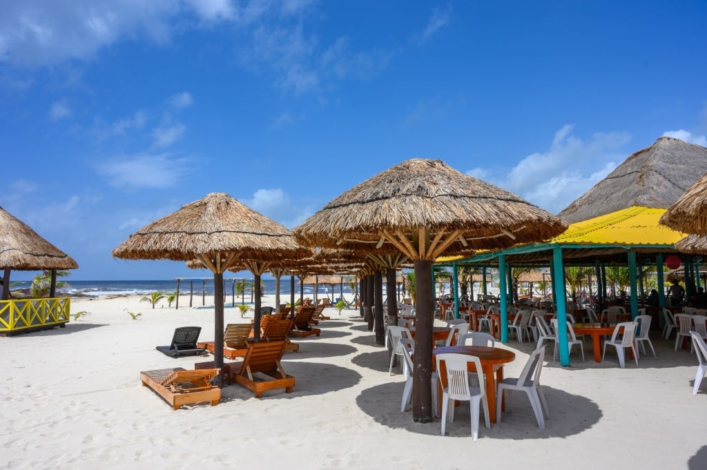 Sandy beach in Cozumel with lounge chairs