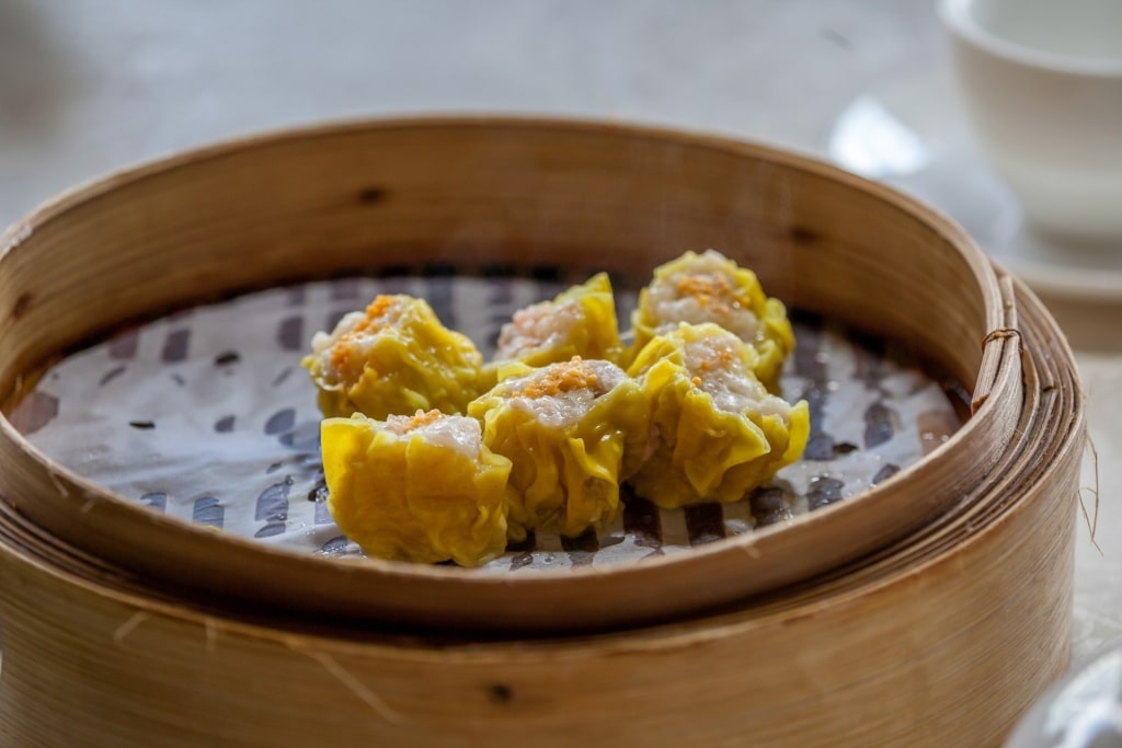 Freshly made siu mai in a bamboo container