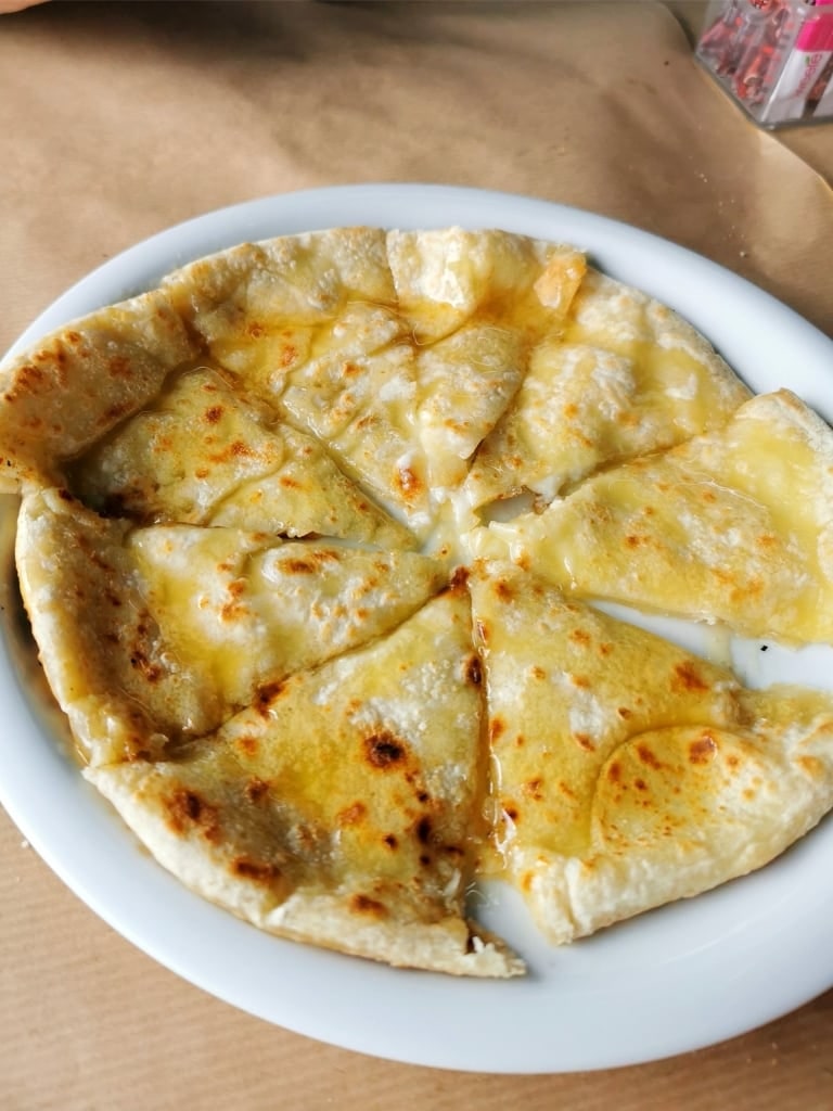 Cheesy sfakiani pita on a plate